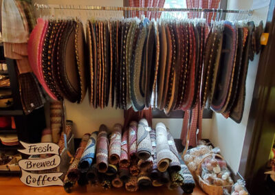 woven rugs hanging on a rack
