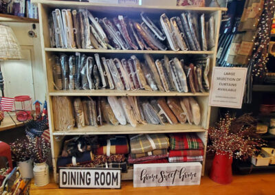 Curtains in a variety of patterns on shelves at Old Homestead